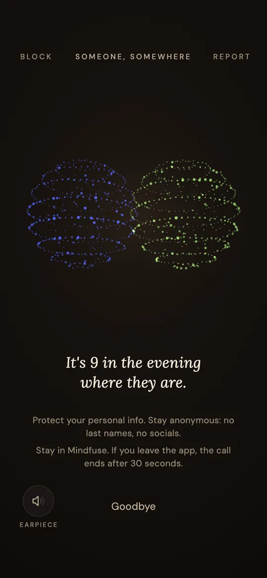 Mindfuse during a call: two orbs of light, one blue and one green, take turns glowing as each voice speaks. The line reads: It's 9 in the evening where they are.
